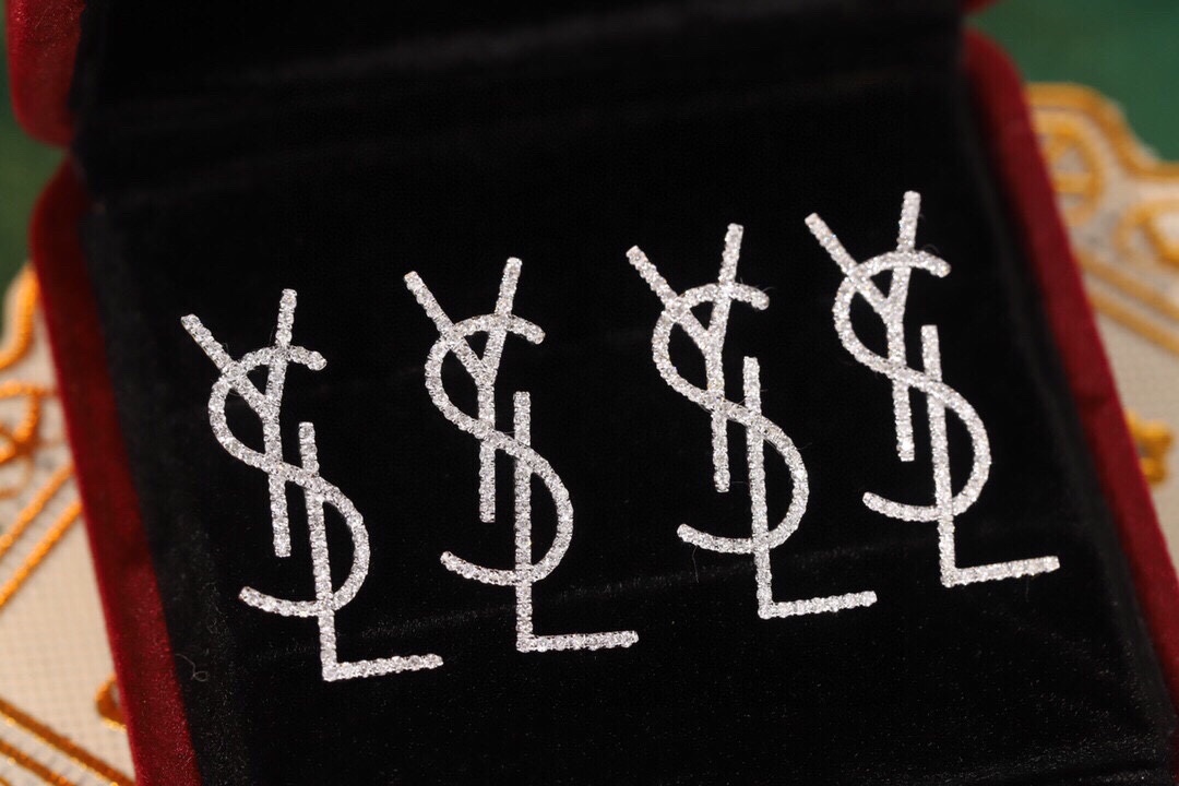 18k Gold Diamond Earrings by YSL Yves Saint Laurent, with a natural diamond of 0.60ct