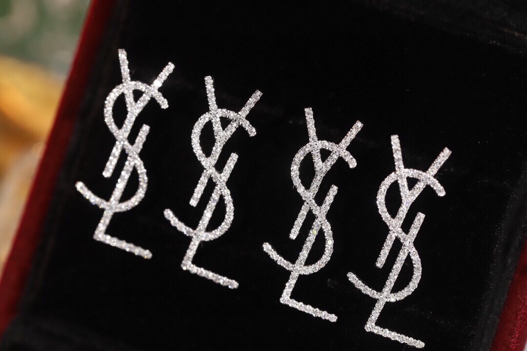 18k Gold Diamond Earrings by YSL Yves Saint Laurent, with a natural diamond of 0.60ct