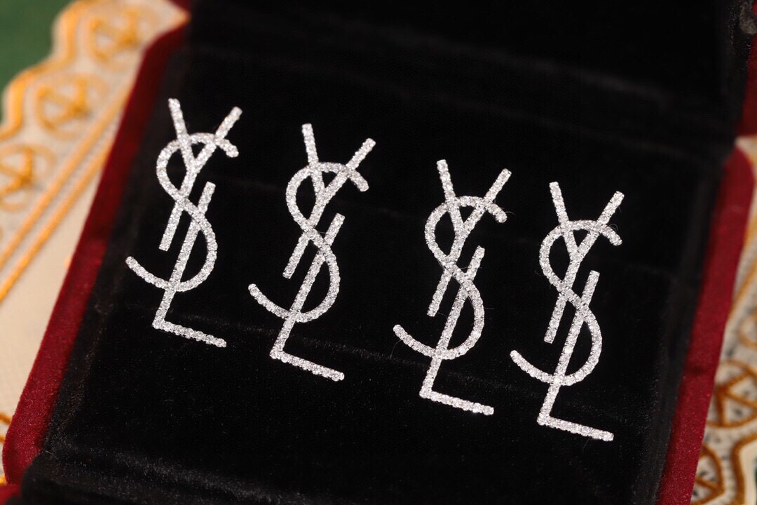 18k Gold Diamond Earrings by YSL Yves Saint Laurent, with a natural diamond of 0.60ct
