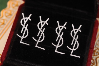 18k Gold Diamond Earrings by YSL Yves Saint Laurent, with a natural diamond of 0.60ct