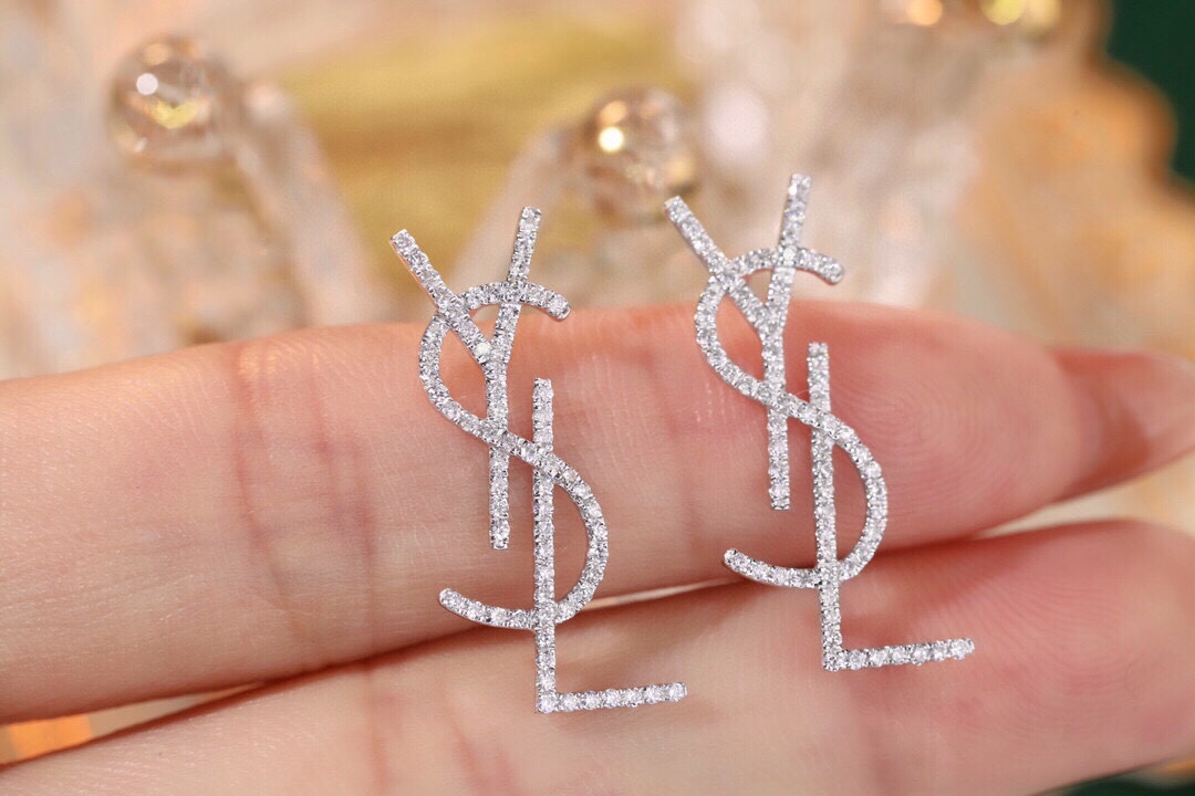 18k Gold Diamond Earrings by YSL Yves Saint Laurent, with a natural diamond of 0.60ct