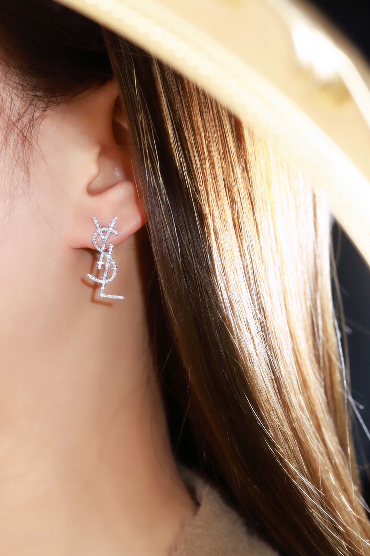 18k Gold Diamond Earrings by YSL Yves Saint Laurent, with a natural diamond of 0.60ct