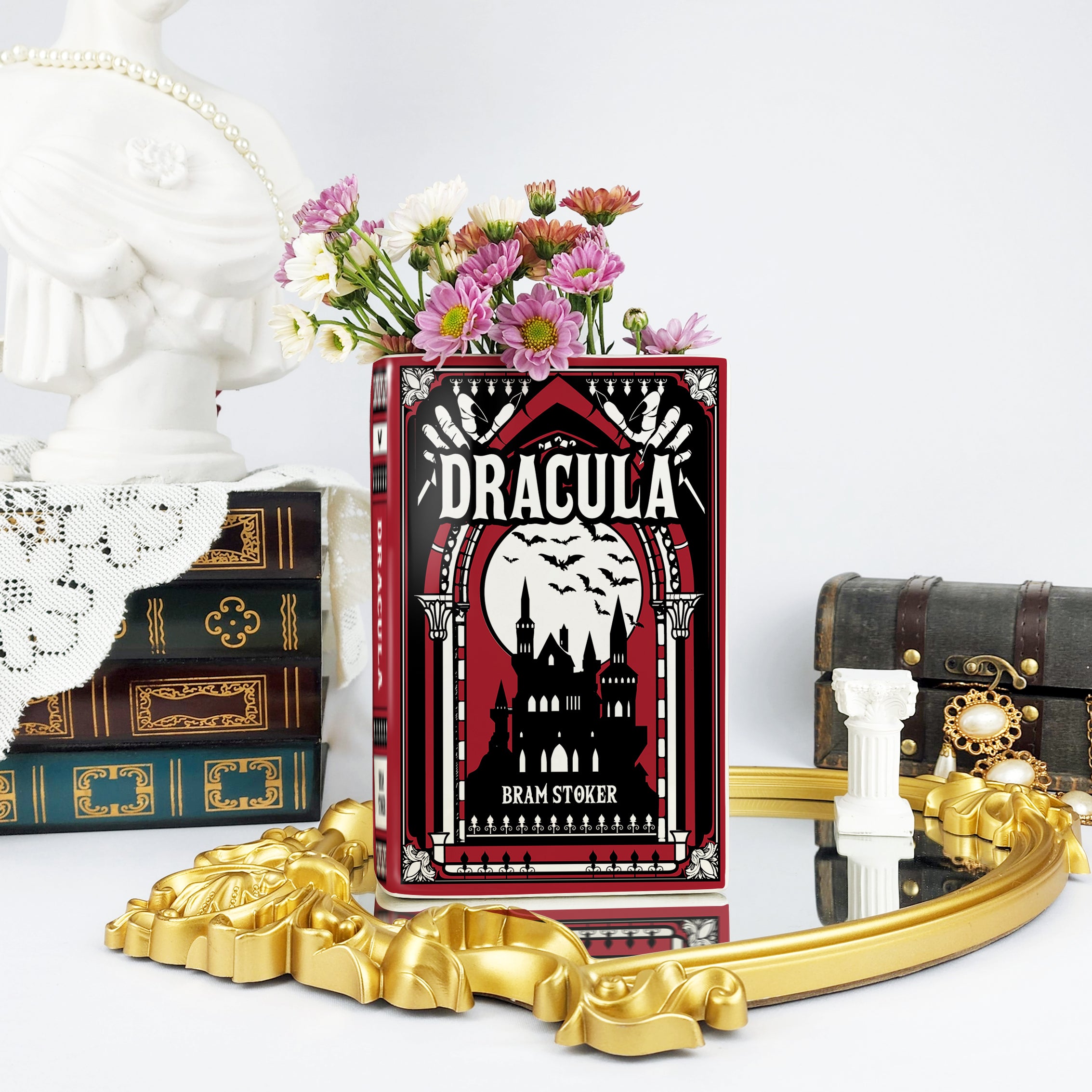Dracula ceramic book vase with flowers, ornate decor, vintage books and gold mirror