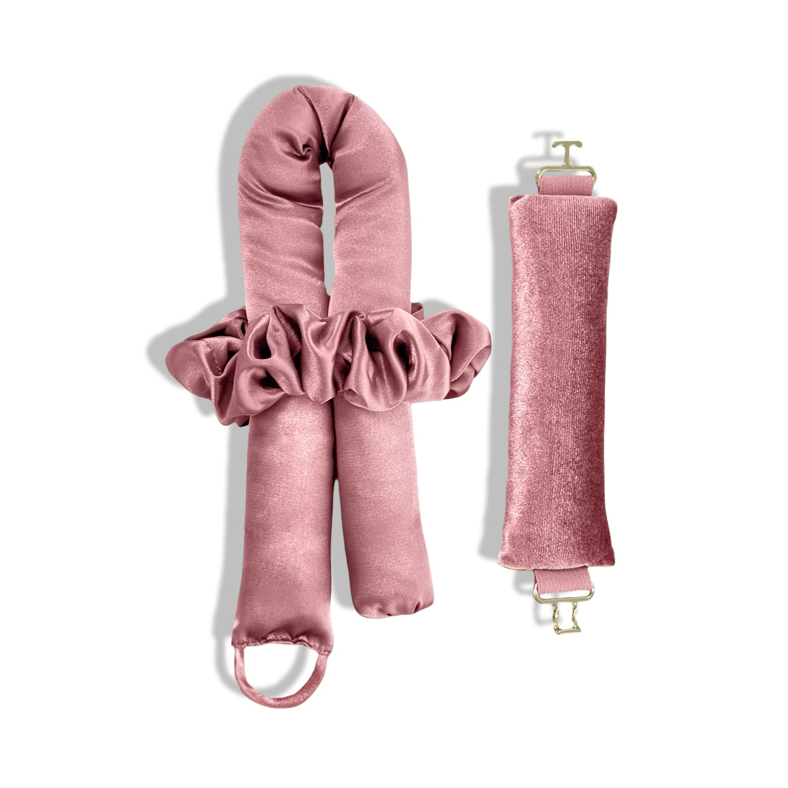 A set of candy pink heatless curlers for side sleepers. and a hair tie, made from Peau De Soie fabric, with gold clasps.