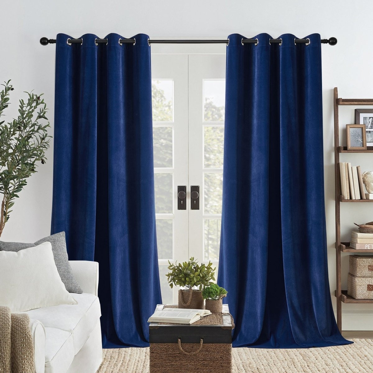 Two royal blue velvet blackout curtains with grommets on rod, covering double doors. Luxurious & thermal insulated.