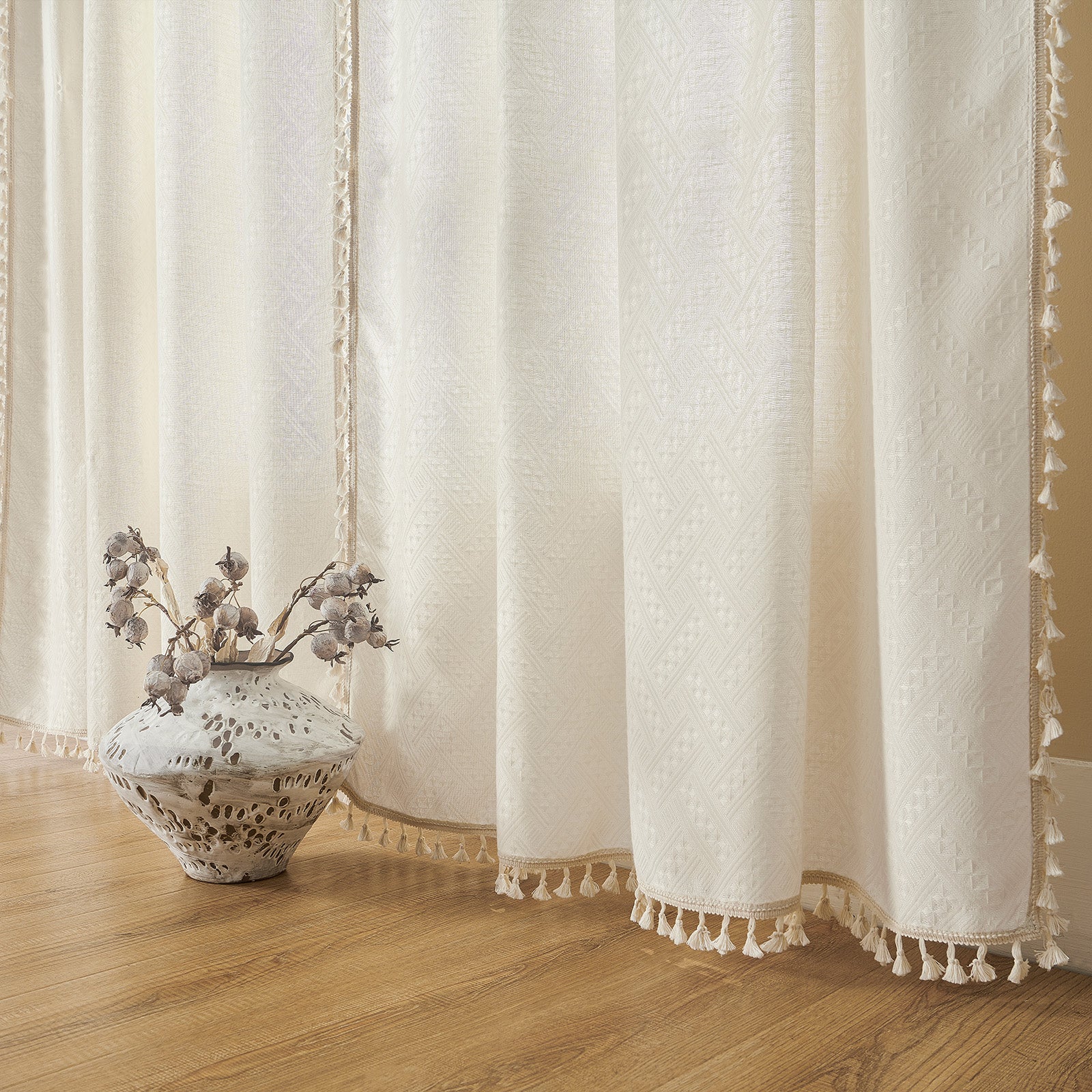 Joydeco off-white woven boho curtains with diamond pattern and cream tassel trim, 84 inches long.