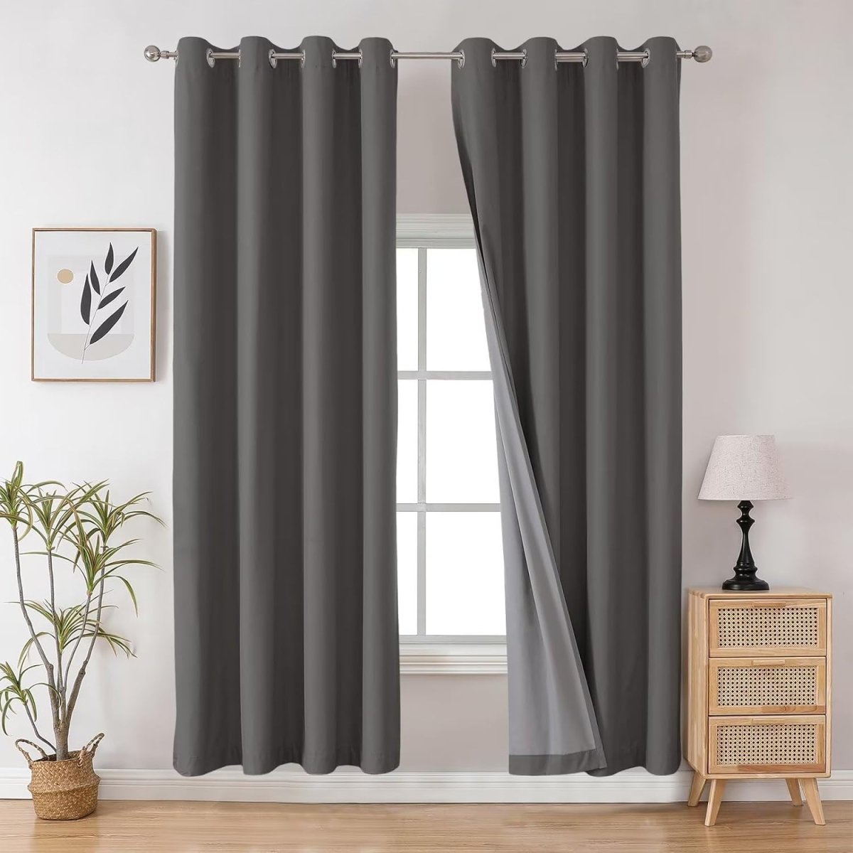 Dark gray Joydeco 100% blackout, thermal insulated grommet curtains, one panel partially open.