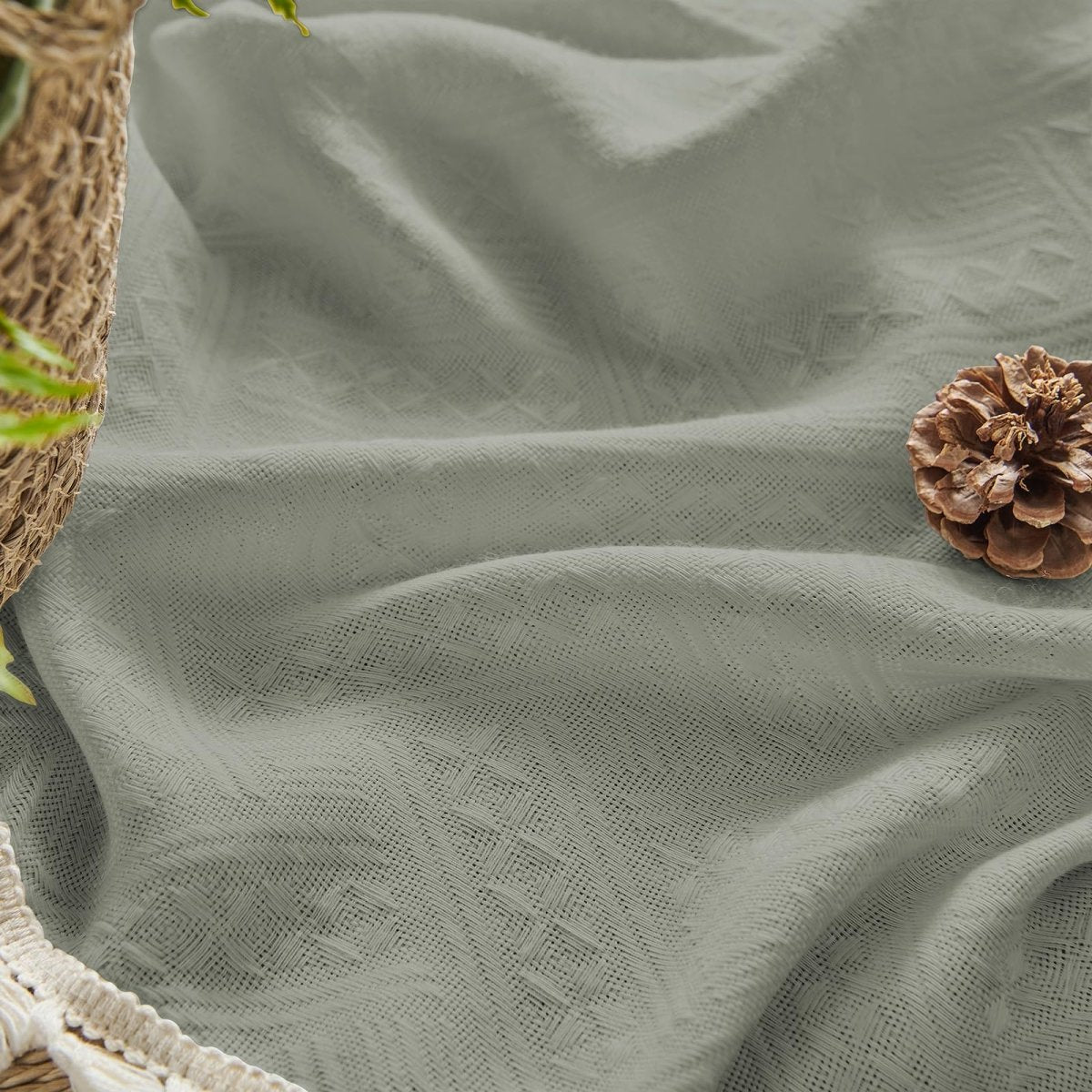 Sage green boho linen sheer curtain texture with geometric pattern and cream tassel trim.