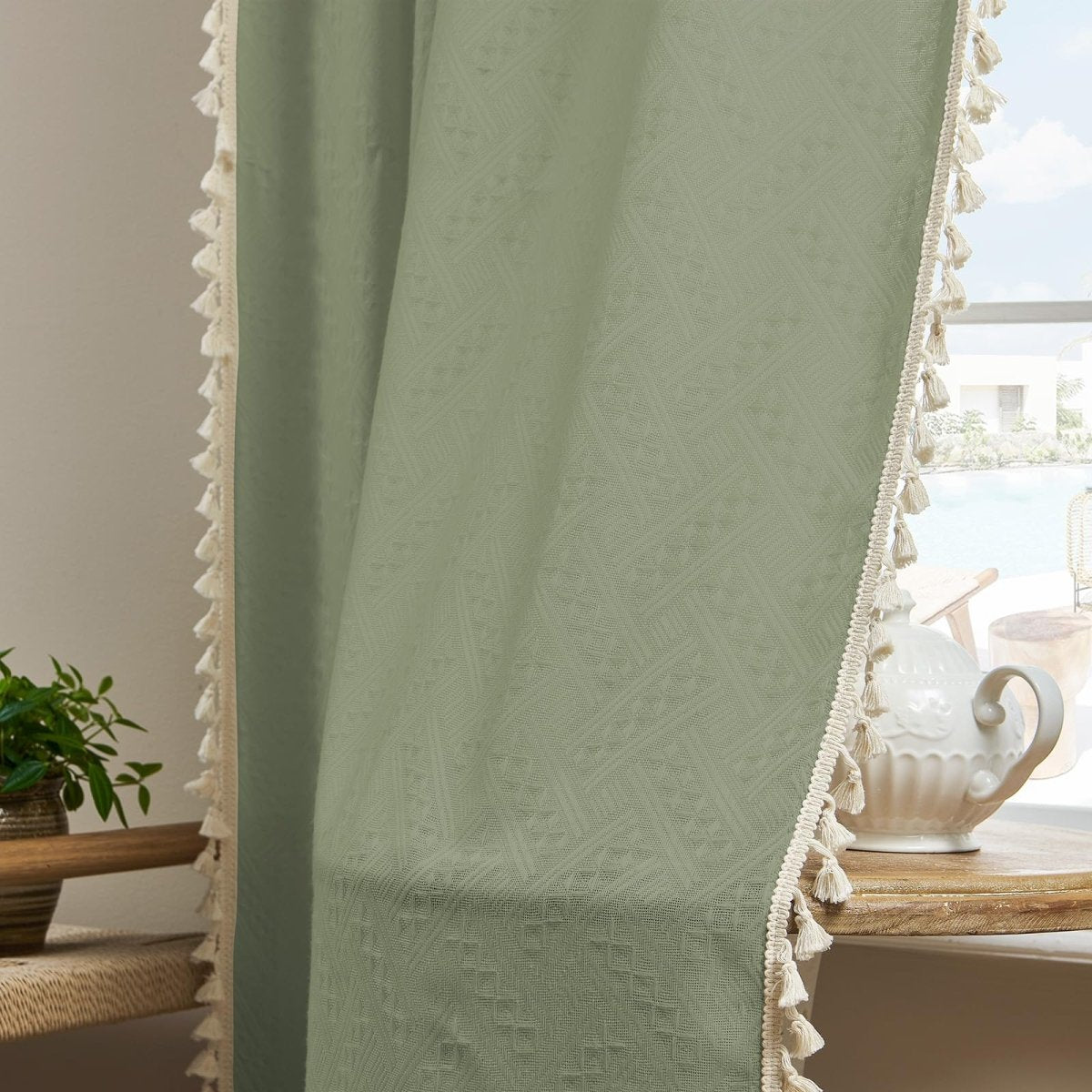 Sage green linen sheer curtains with diamond weave texture and cream tassels, farmhouse boho style.