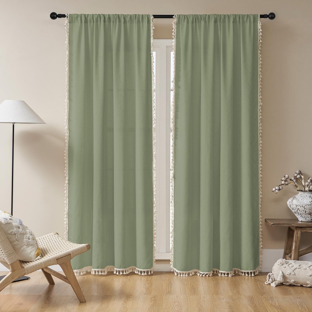 Sage green linen boho curtains with cream tassels, light filtering, farmhouse style.