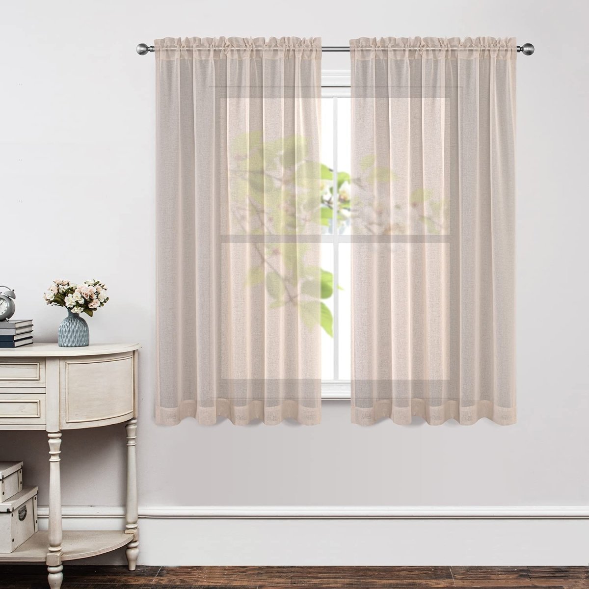 Beige floral embroidery linen-blend sheer curtains, rod pocket, filtering light in a bright living room.