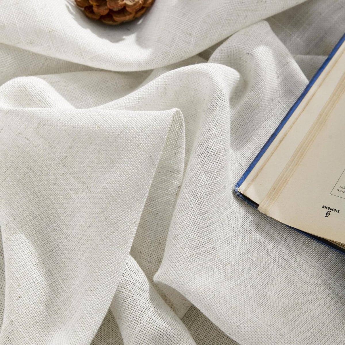 Joydeco white semi-sheer linen blend pinch pleated curtain fabric texture close-up with soft folds.