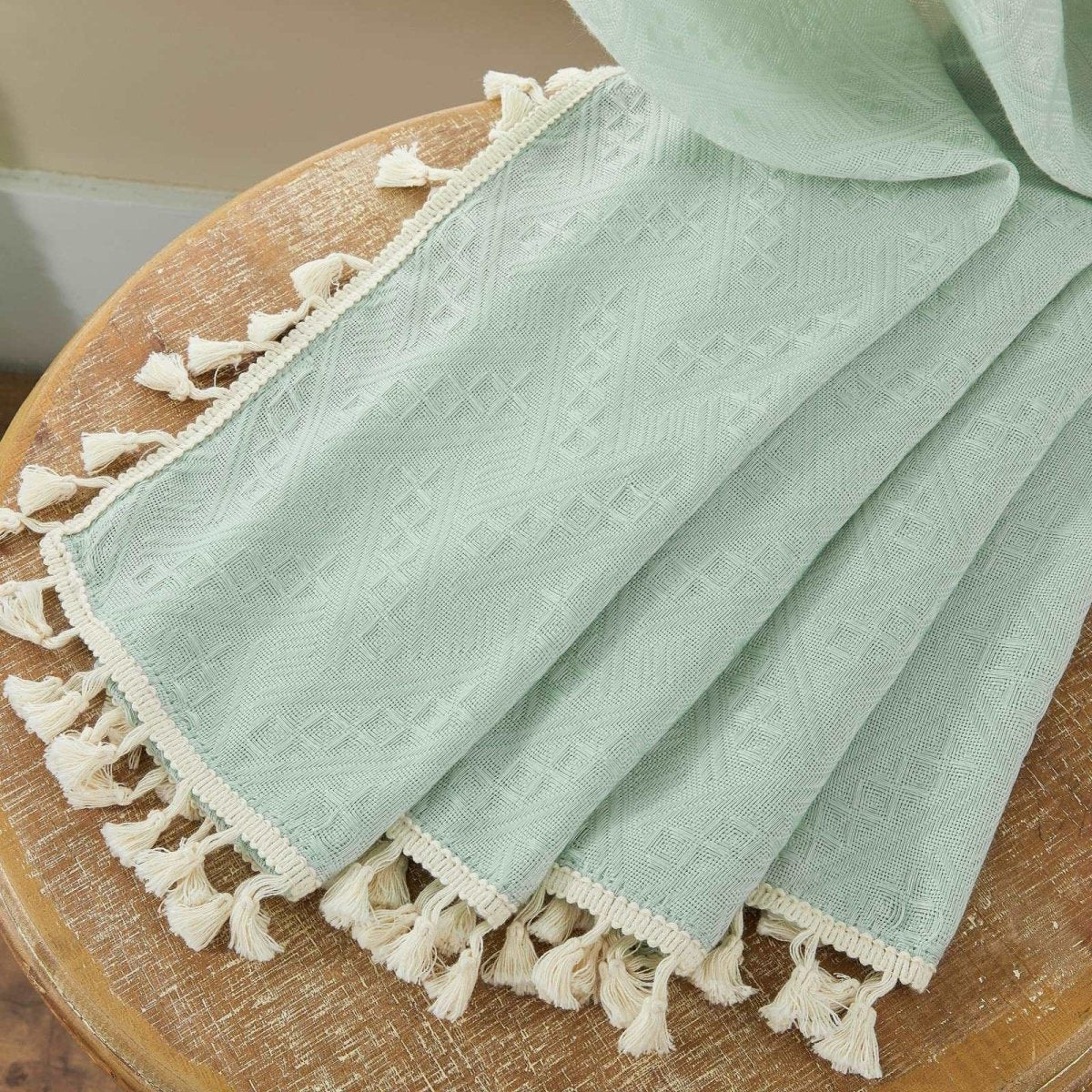 Mint green boho linen sheer curtain texture with diamond embroidery and cream tassel trim.