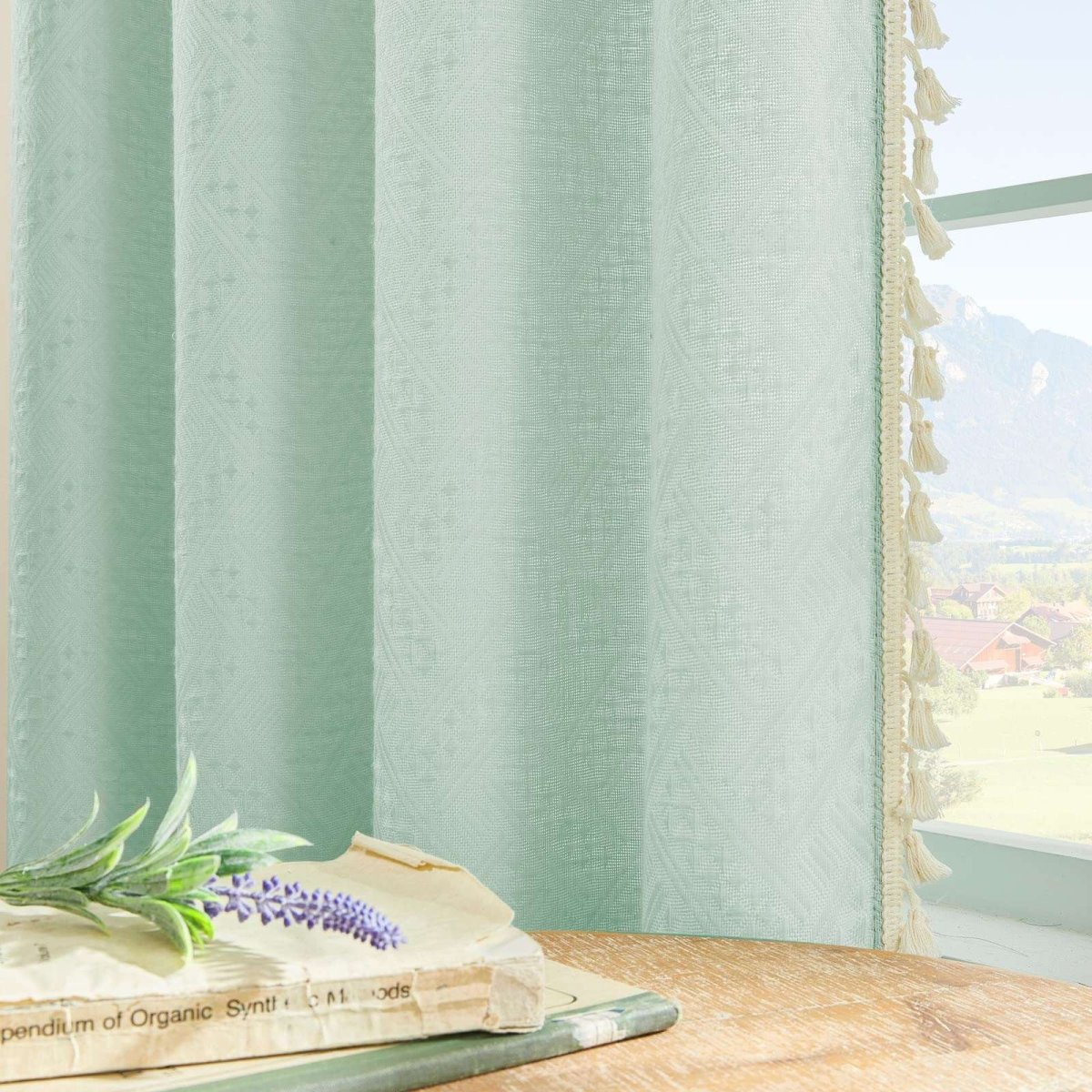 Joydeco mint green linen blend sheer curtains with diamond embroidery and cream tassel trim, filtering sunlight.