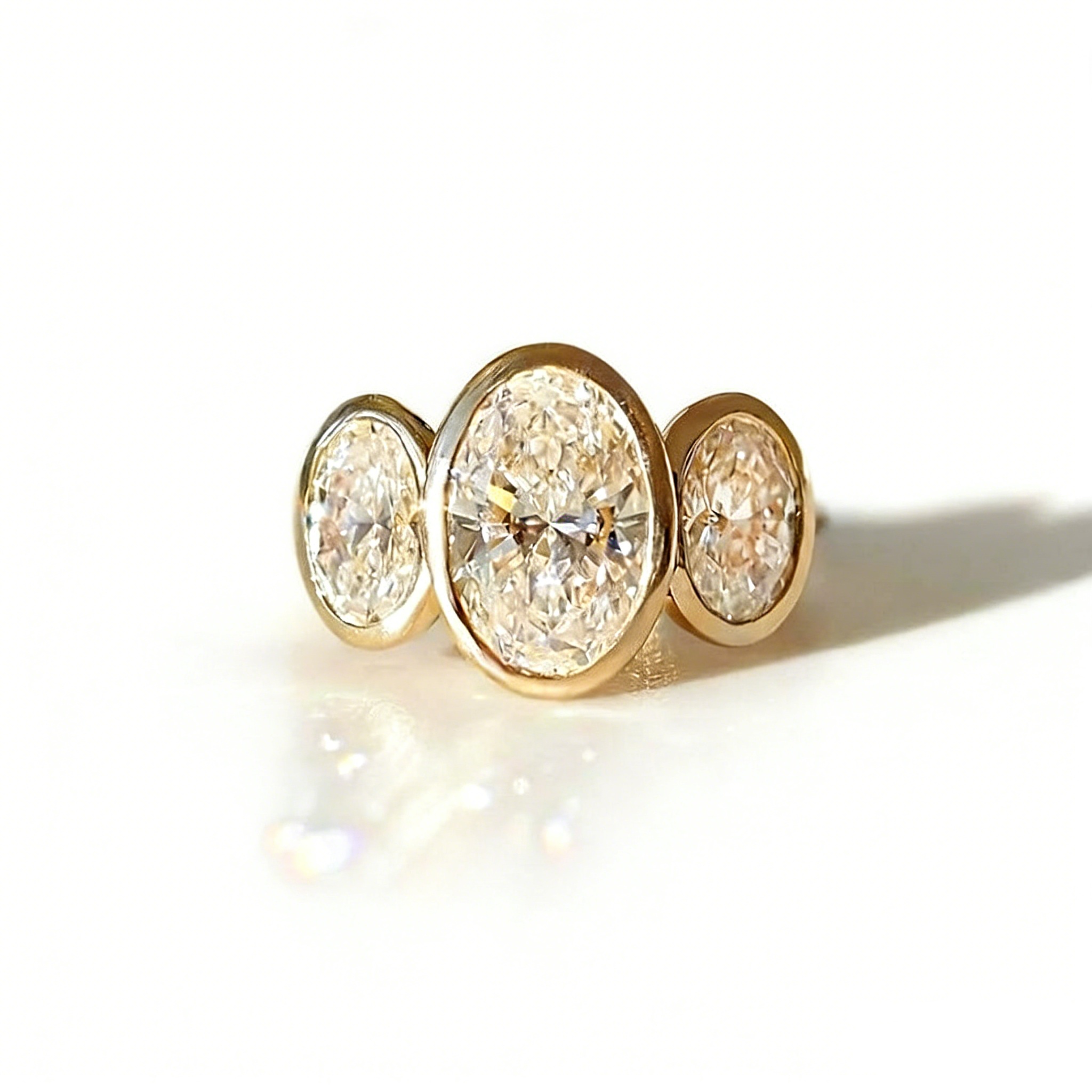 Gilded Circle Harmony 18K Gold Bezel-Set Three-Stone Ring