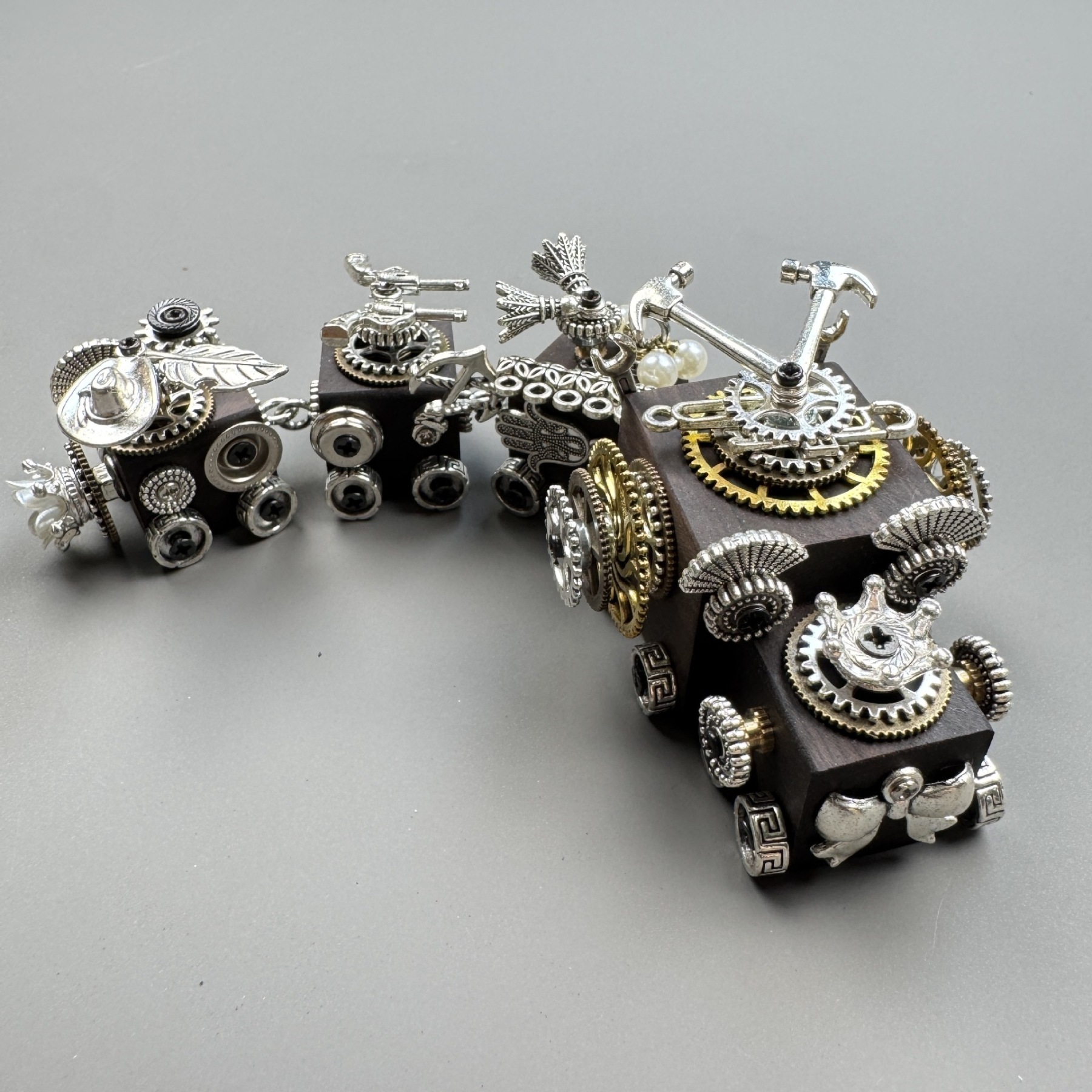 A versatile accessory that works as both a phone charm and a necklace pendant.