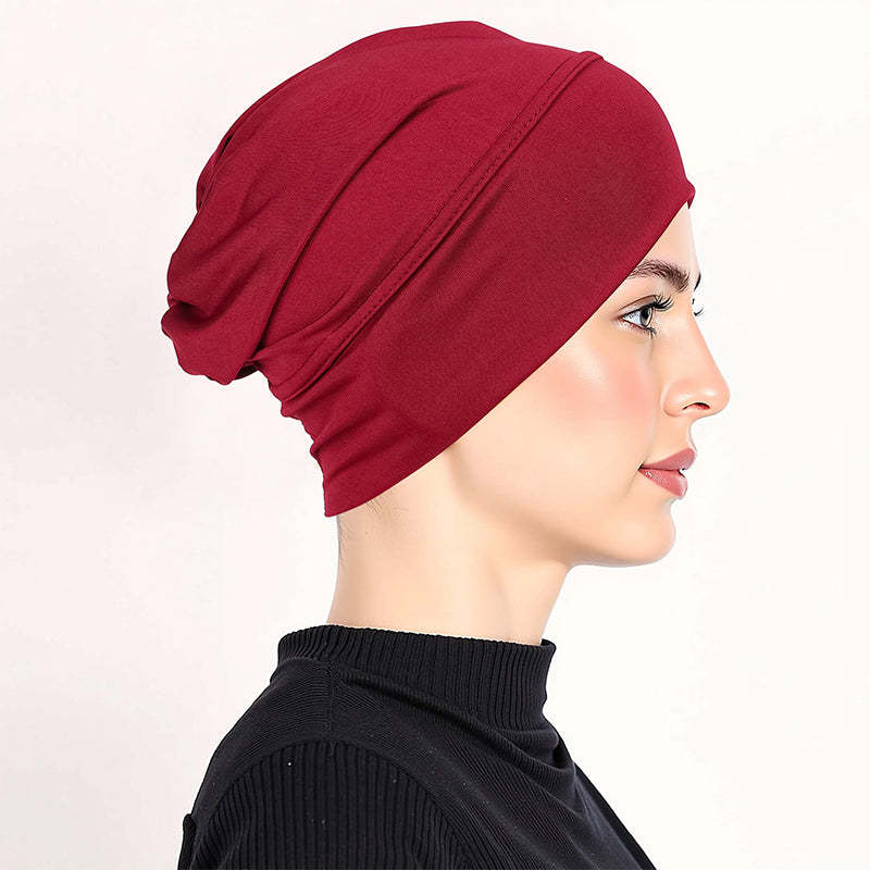 Smart och stretchig under-scarf mössa för en slät och bekväm frisyr hela dagen