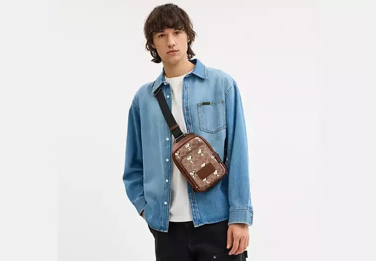 Coach X Peanuts Racer Sling Pack In Signature Canvas With Snoopy Print