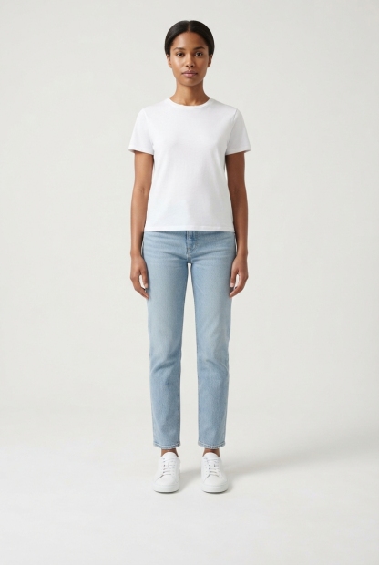 Model standing wearing white walking sneakers, both shoes visible.