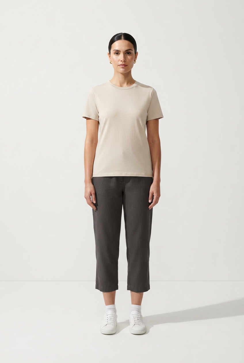Model wearing beige cotton T-shirt outdoors with full body visible.