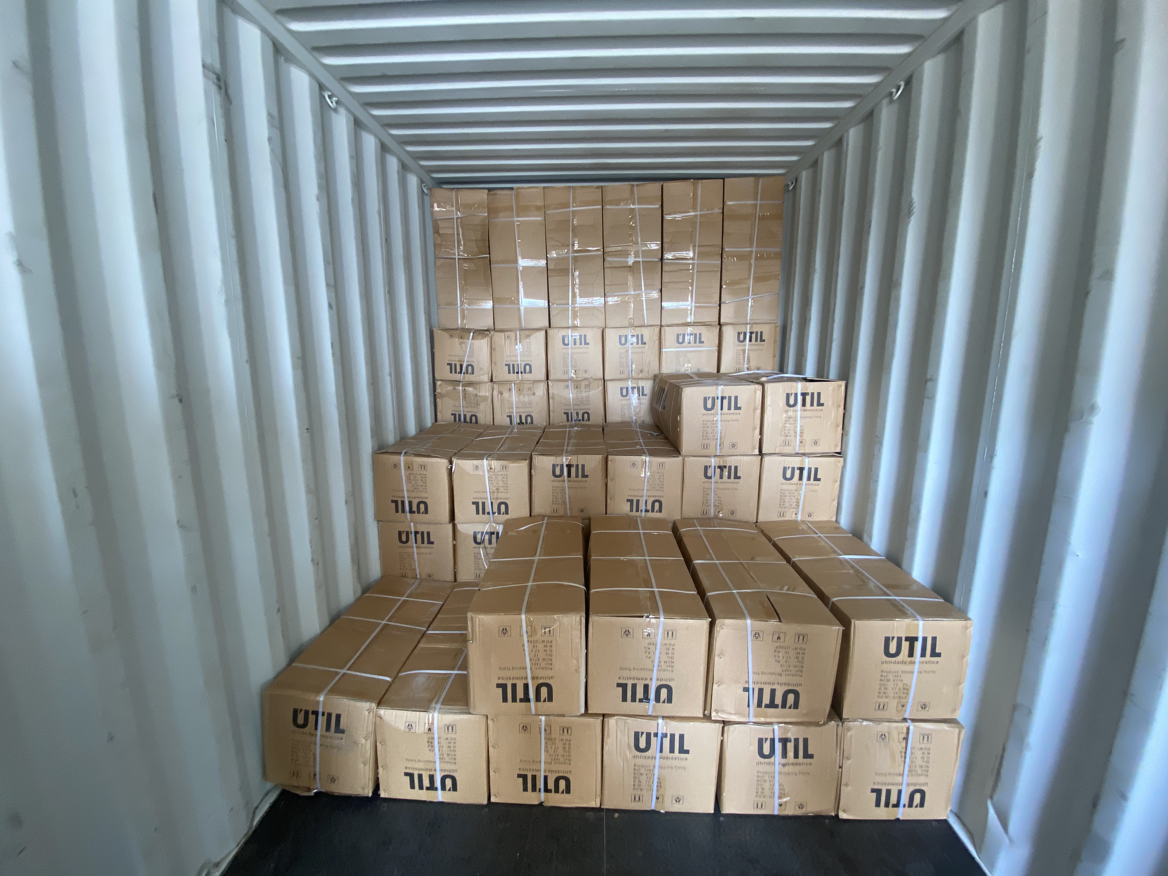 {"default":"Workers loading cargo boxes onto a logistics truck from a warehouse loading dock"}
