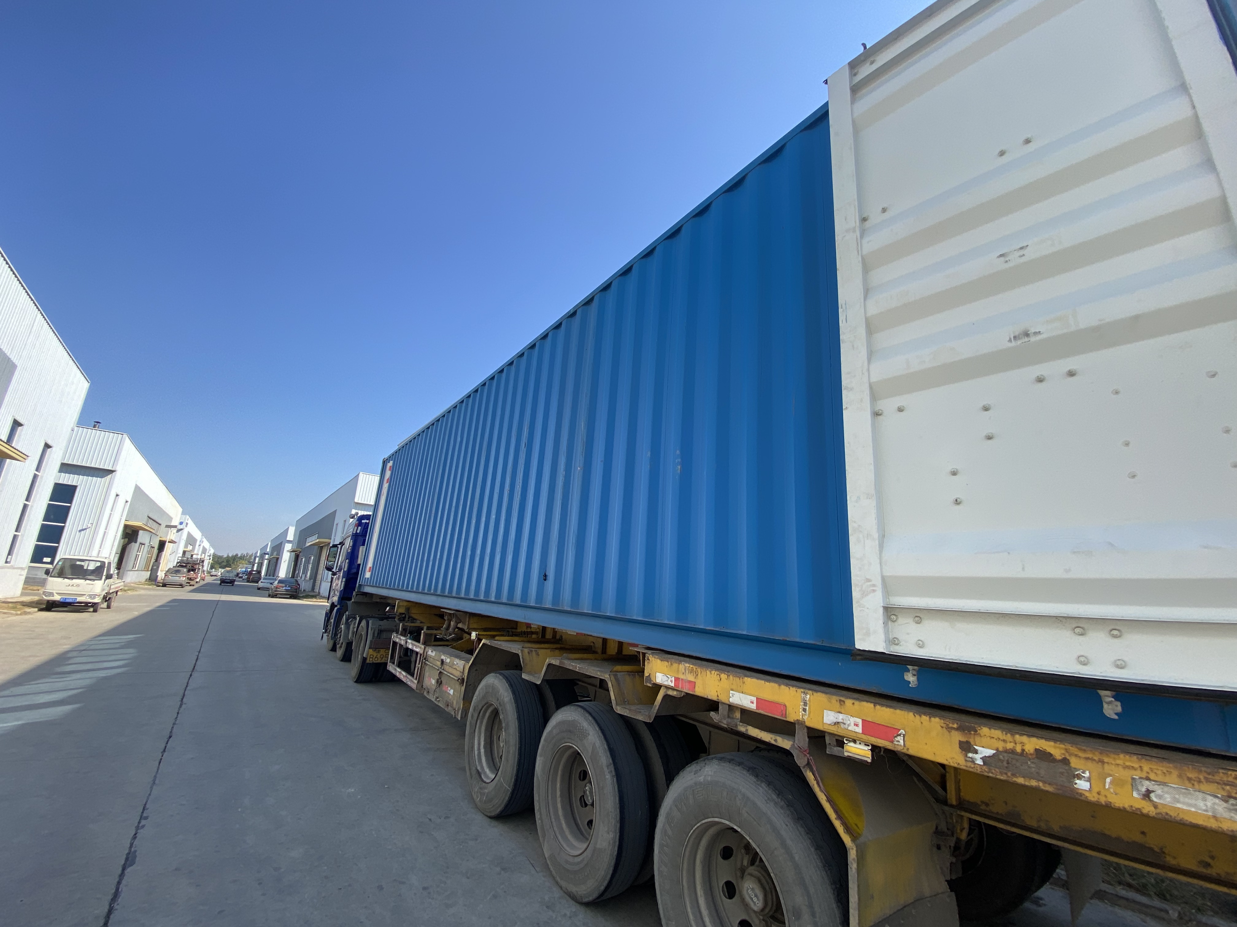 {"default":"A heavy-duty freight truck carrying a shipping container on a highway symbolizes long-haul logistics and supply chain transportation."}
