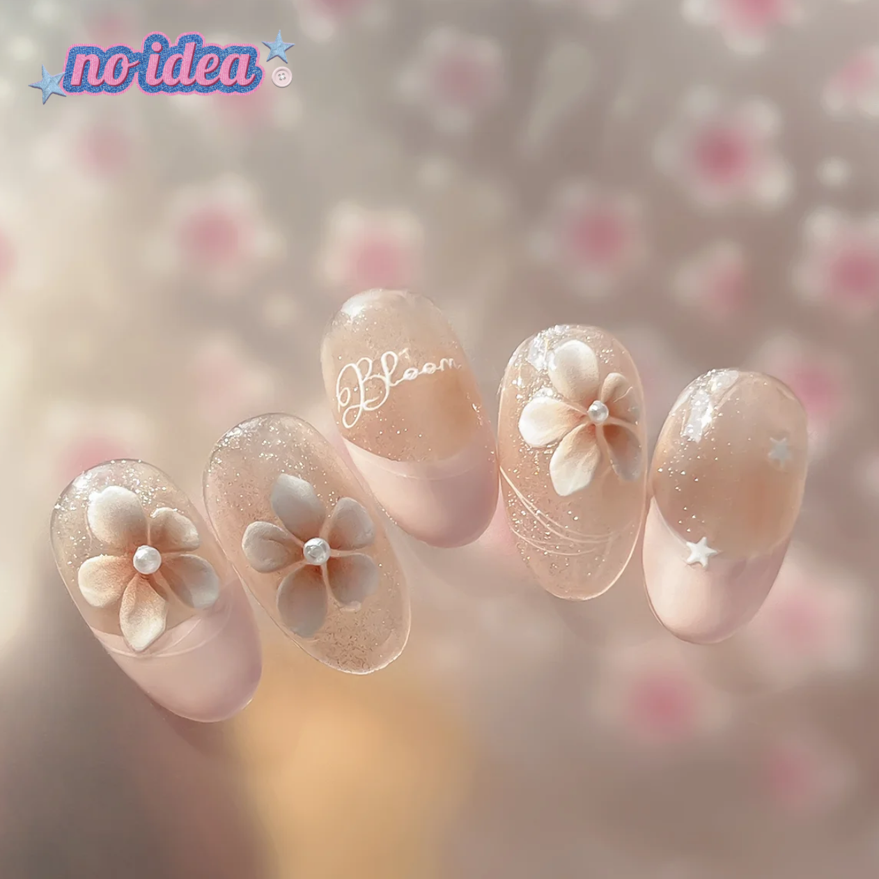 Press on nail with shining nude base and floral designs.