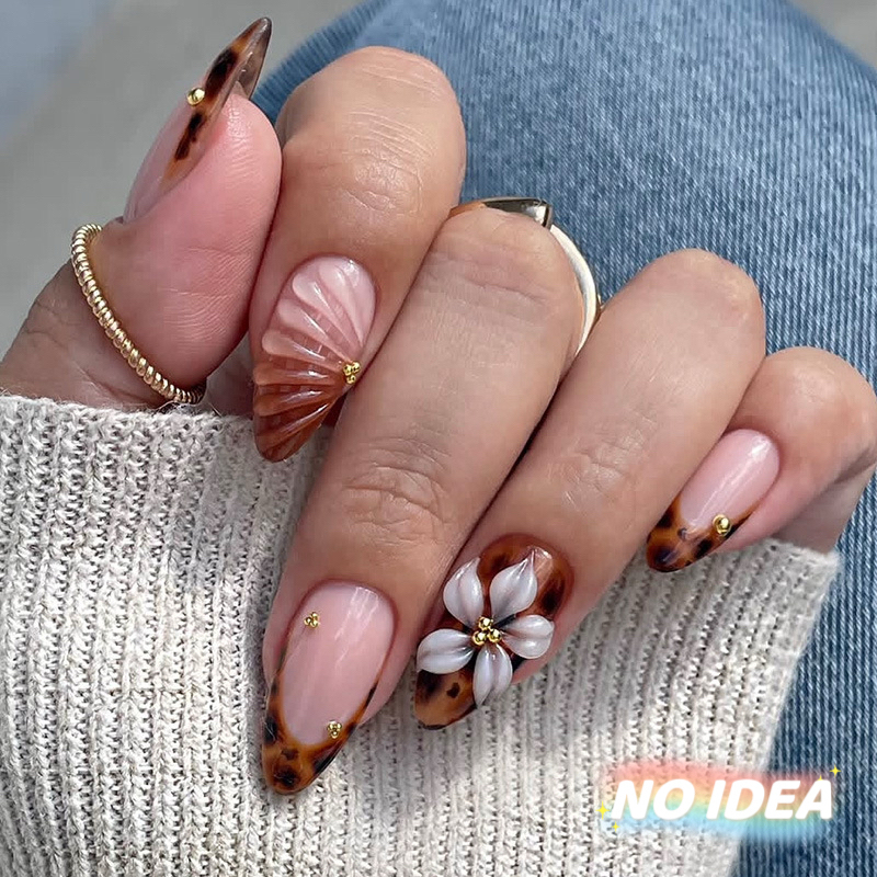Almond shaped nails with a wine red French tip and delicate white waterdrop flower designs.