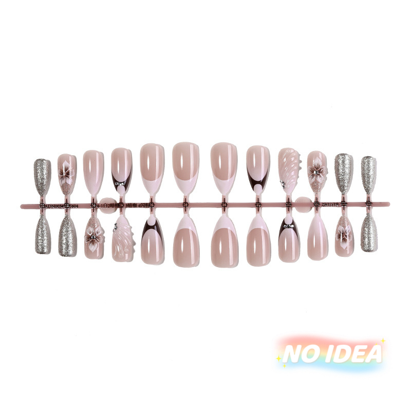 Almond shaped nails with a nude/white French tip and metallic pearl & seashell embellishments.