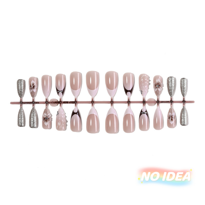 Almond shaped nails with a nude/white French tip and metallic pearl & seashell embellishments.