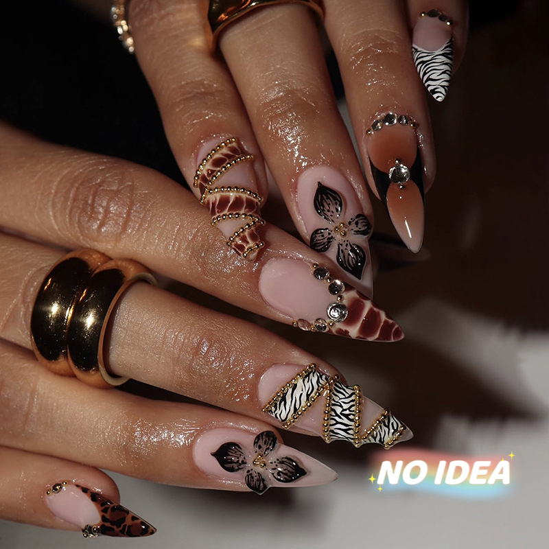 Almond shaped nude press on nails with a classic black zebra print stripe.