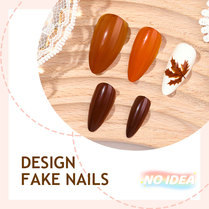 Almond shaped press on nails in a warm gradient of autumn orange and brown colors.