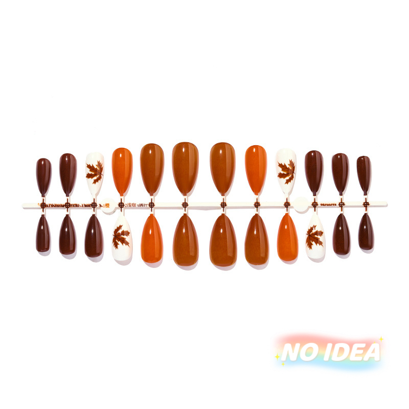 Almond shaped press on nails in a warm gradient of autumn orange and brown colors.