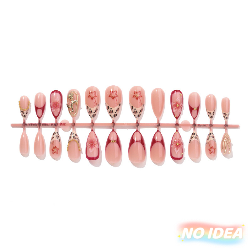 Almond shaped nails with a nude French tip, leopard print, and small floral details.