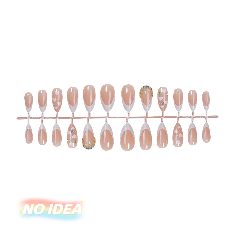 Almond shaped press on nails with a nude base, white French tips, and small white heart designs.