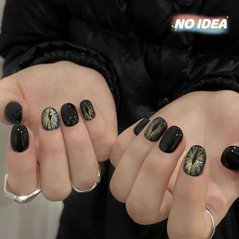 Short black cat eye effect press on nails with a magnetic shimmer, shown in a set of 10.


