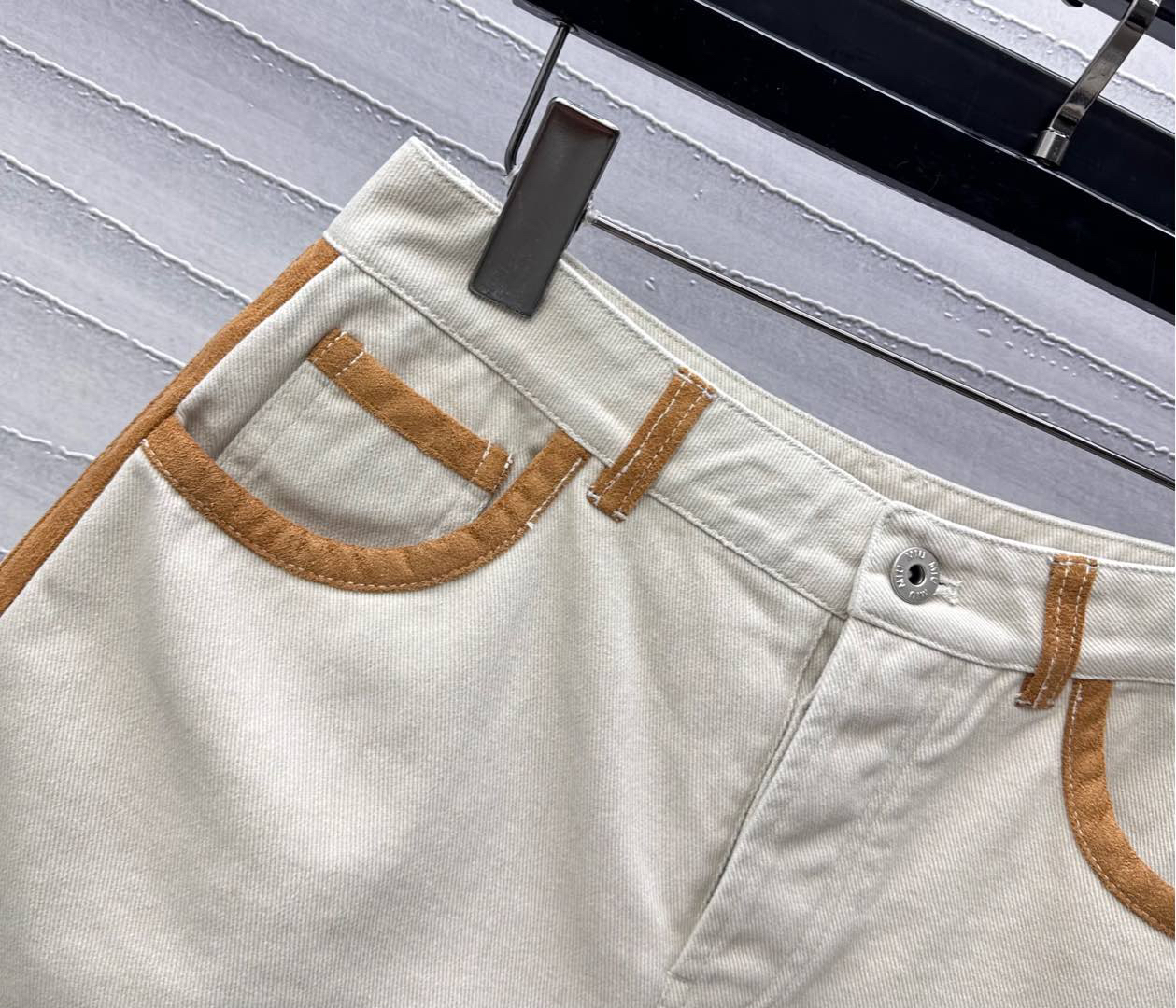 MIU25SS wrap-around patchwork denim shorts