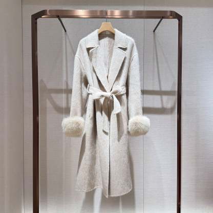 White coat with fur-trimmed sleeves, belted collar, and warm double-faced wool fabric