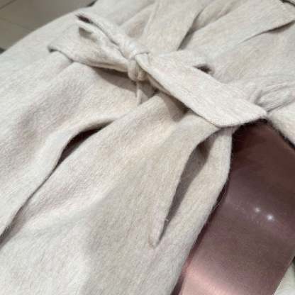 White coat with fur-trimmed sleeves, belted collar, and warm double-faced wool fabric