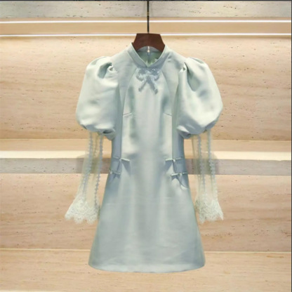 Cheongsam-style dress with bead embellishments, bow detail, lace, and puff sleeves