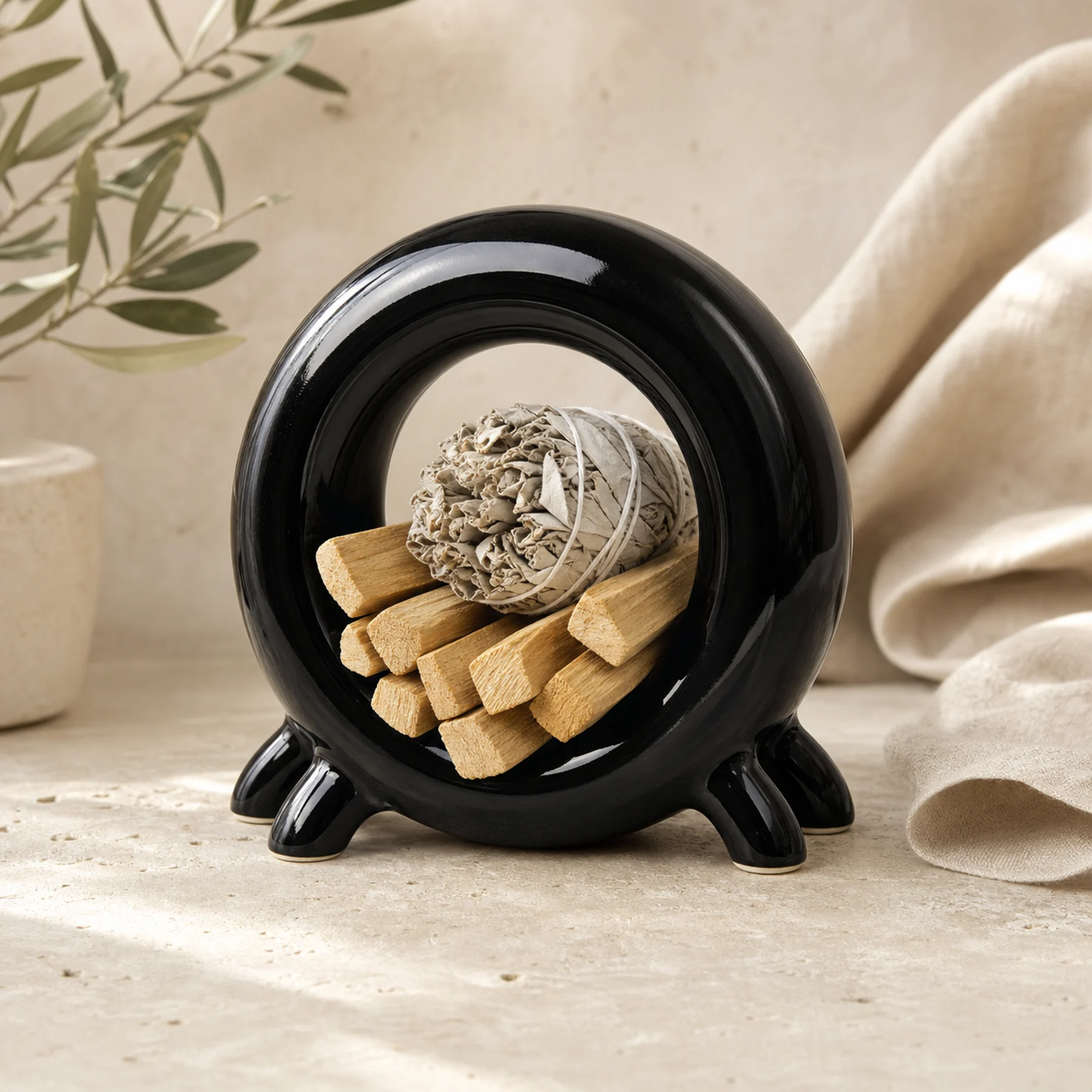 Glossy black ceramic holder displaying dry Palo Santo sticks and sage