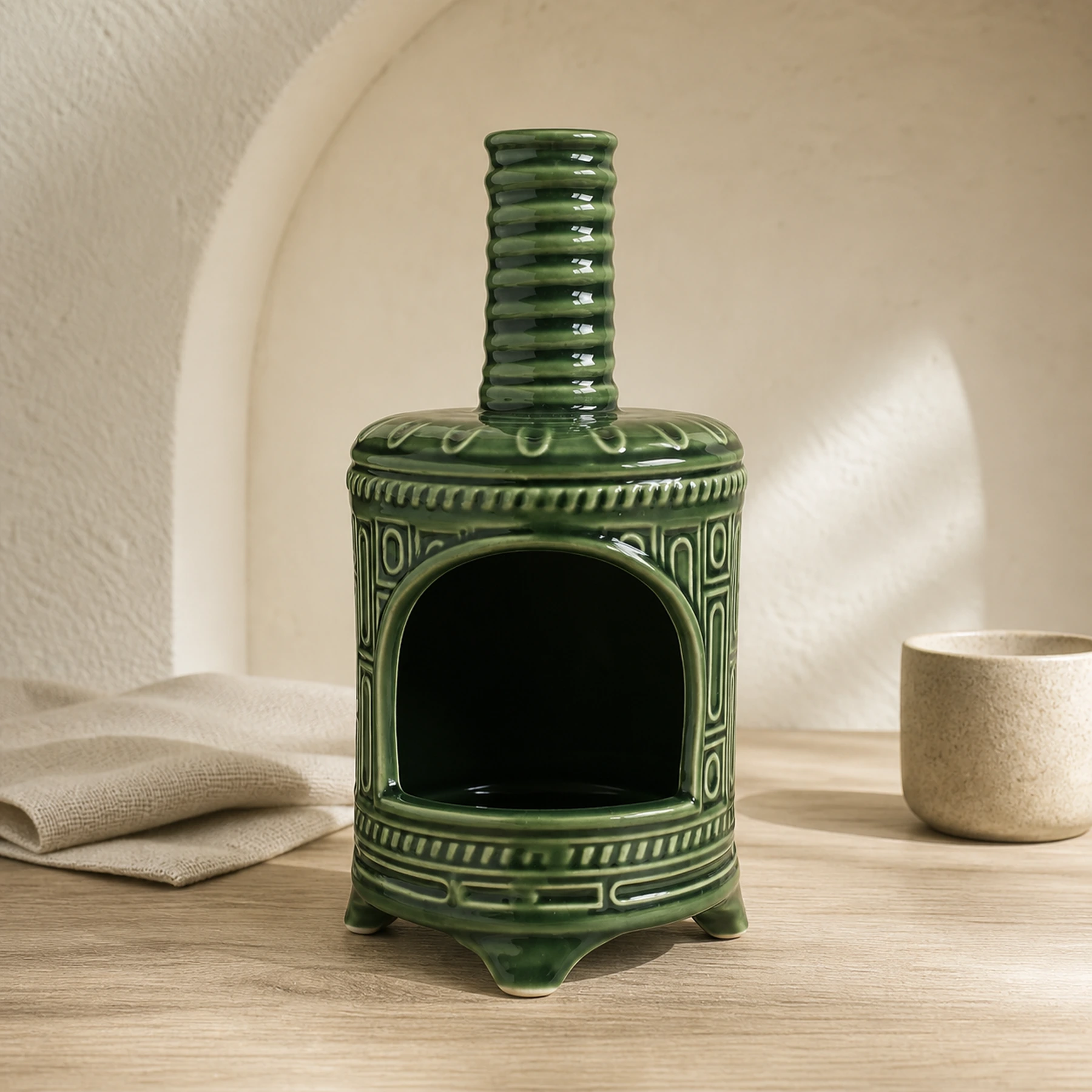Green ceramic Palo Santo holder empty in a clean front product view
