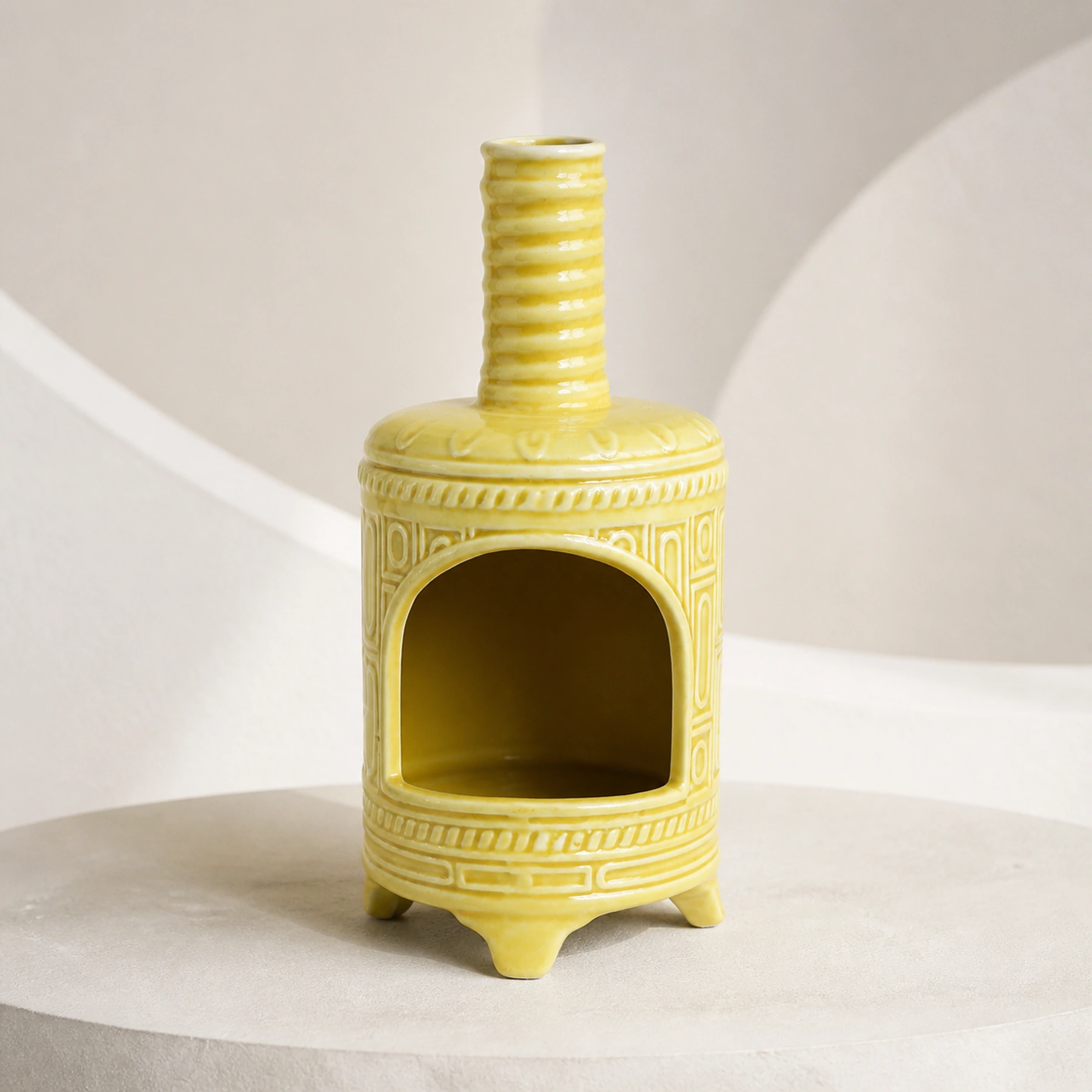 Yellow ceramic Palo Santo holder empty in a clean front product view