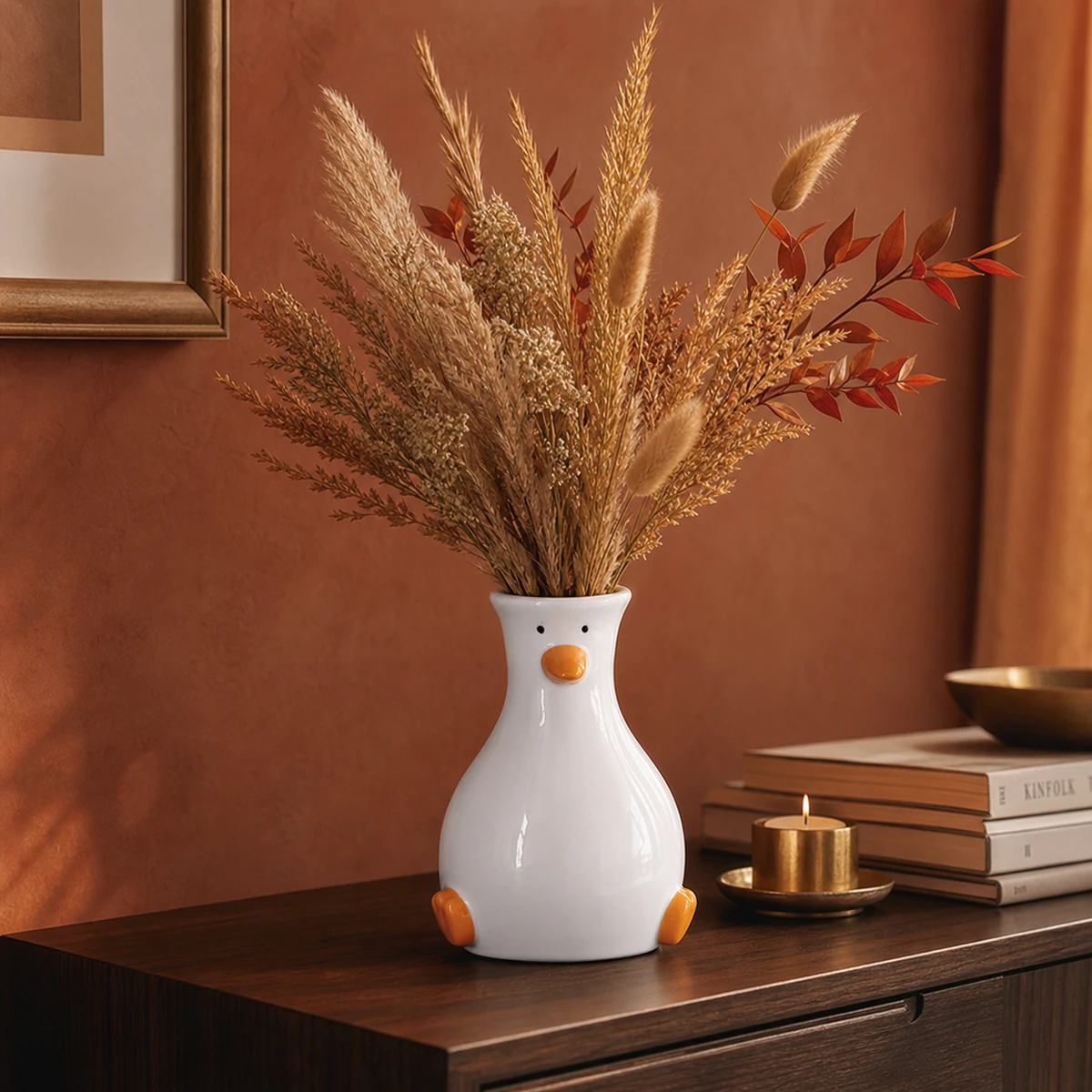 Ceramic duck vase with dried golden grasses on a walnut sideboard