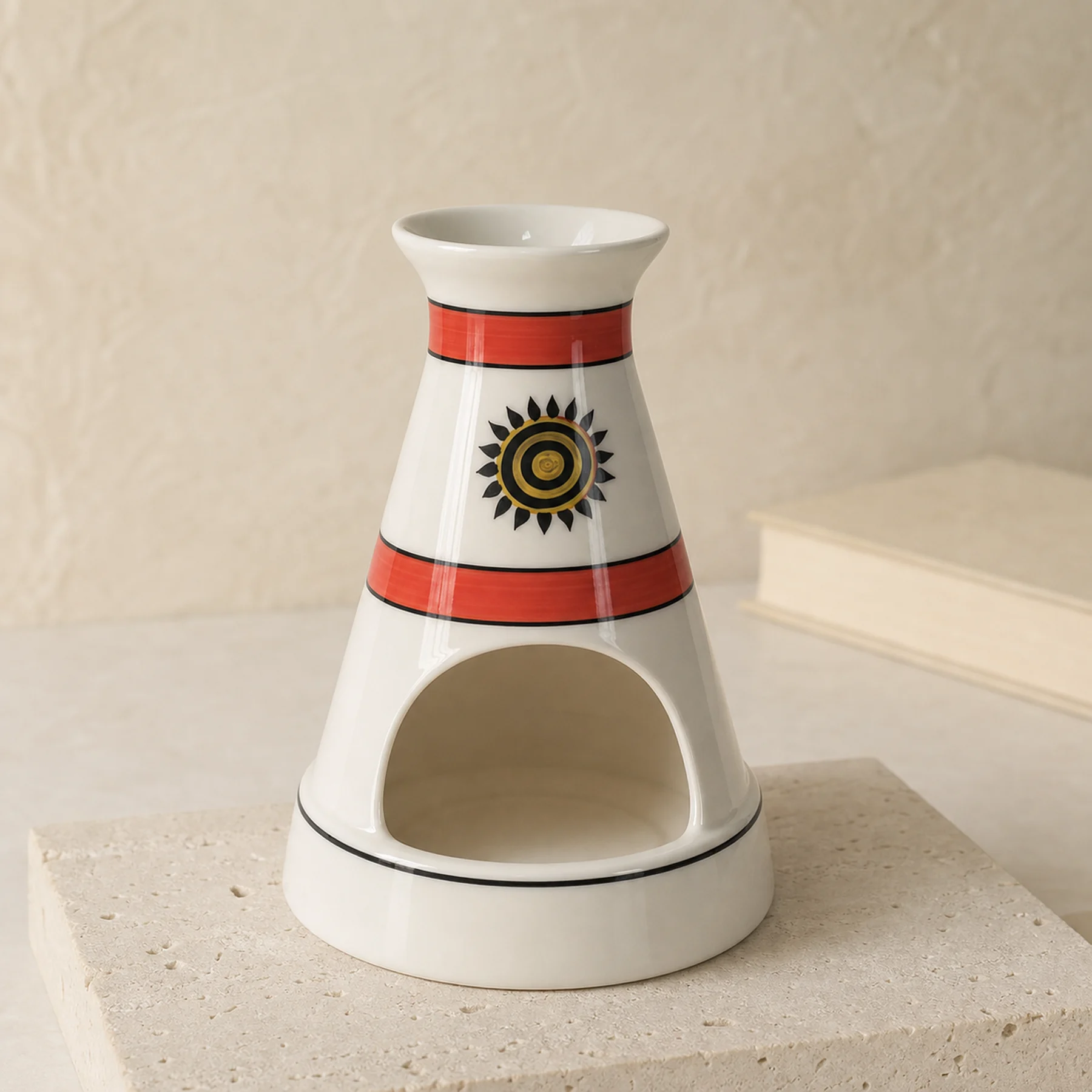 White ceramic sun motif Palo Santo holder on pale travertine