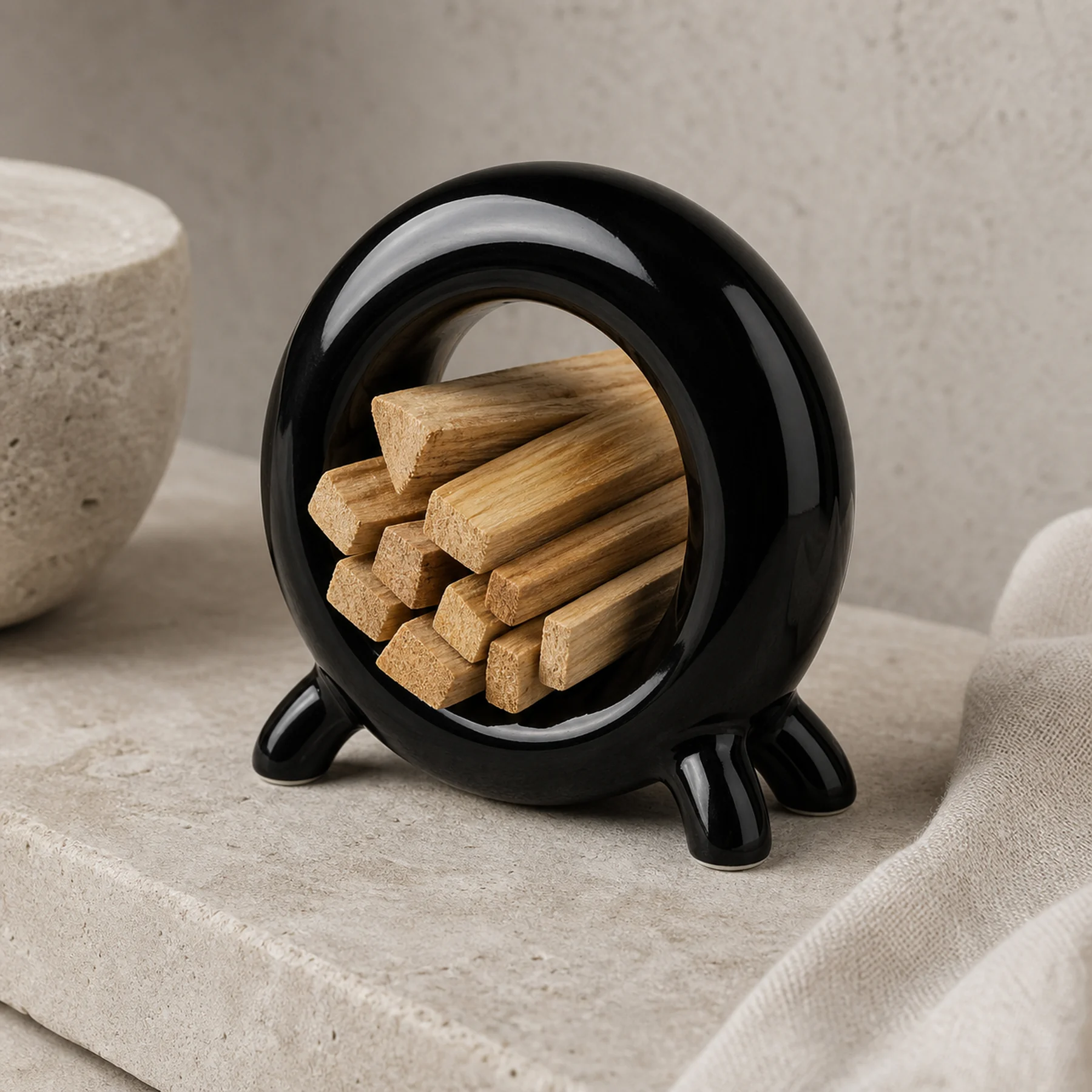 Glossy black ceramic holder storing dry unlit Palo Santo sticks