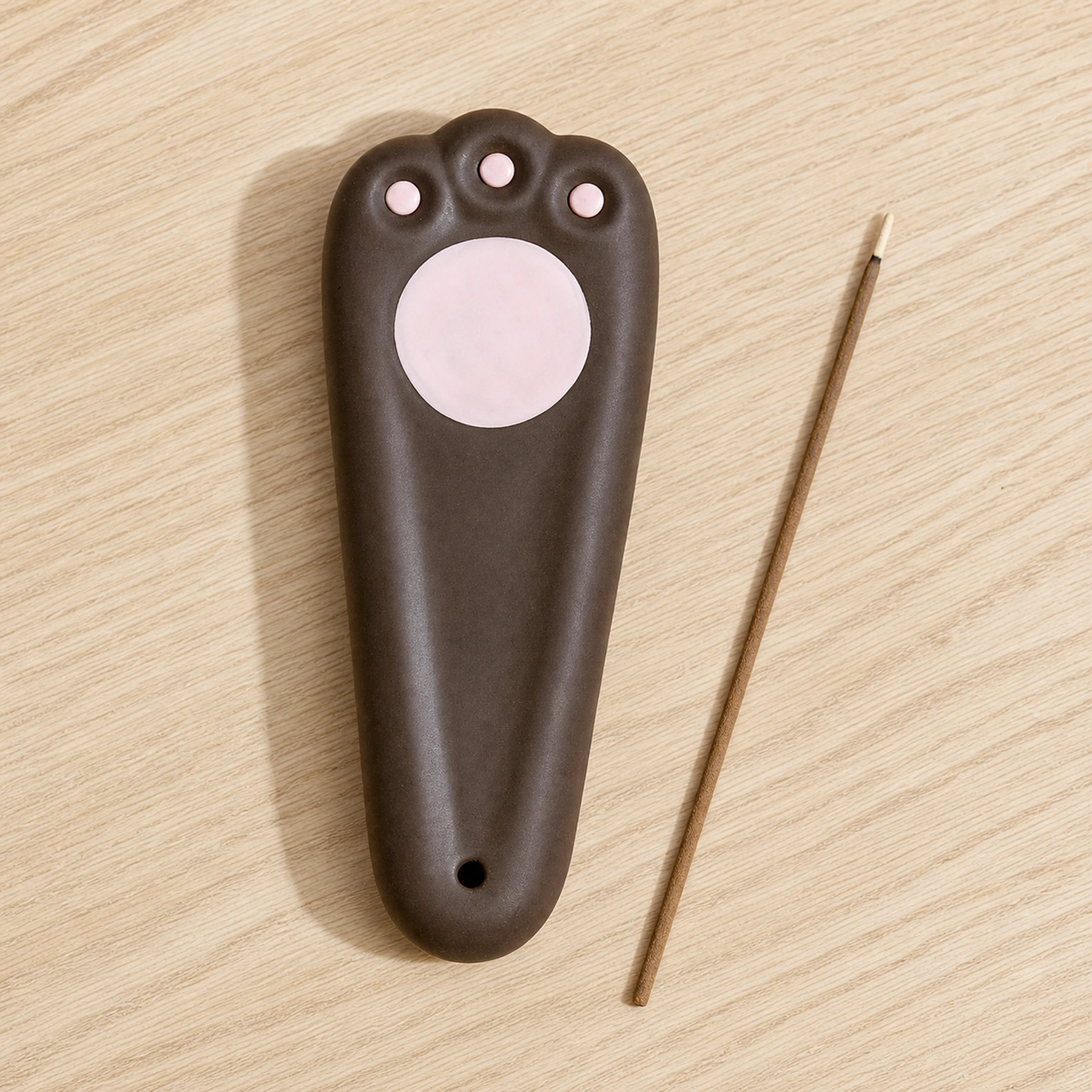 Dark brown ceramic paw incense holder top design and ash channel