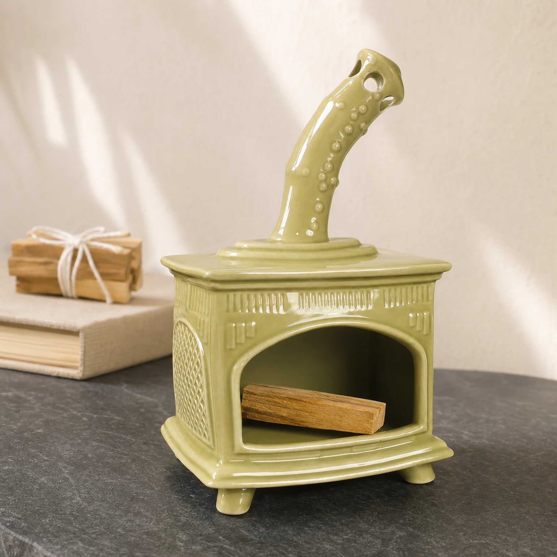 Light Green ceramic fireplace incense holder with unlit Palo Santo placed in the open hearth