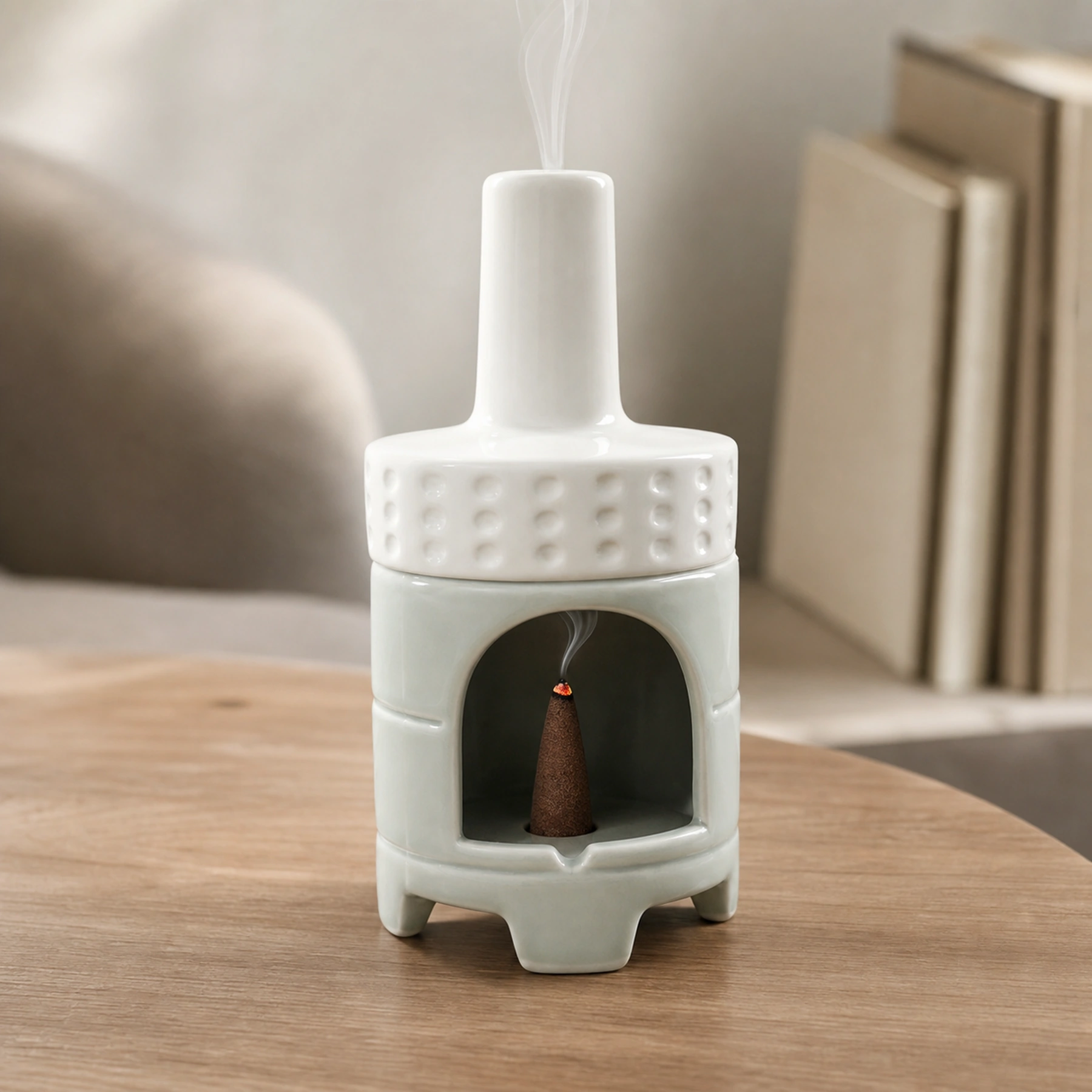 White Green ceramic incense burner with a tapered cone ember and smoke rising through the chimney