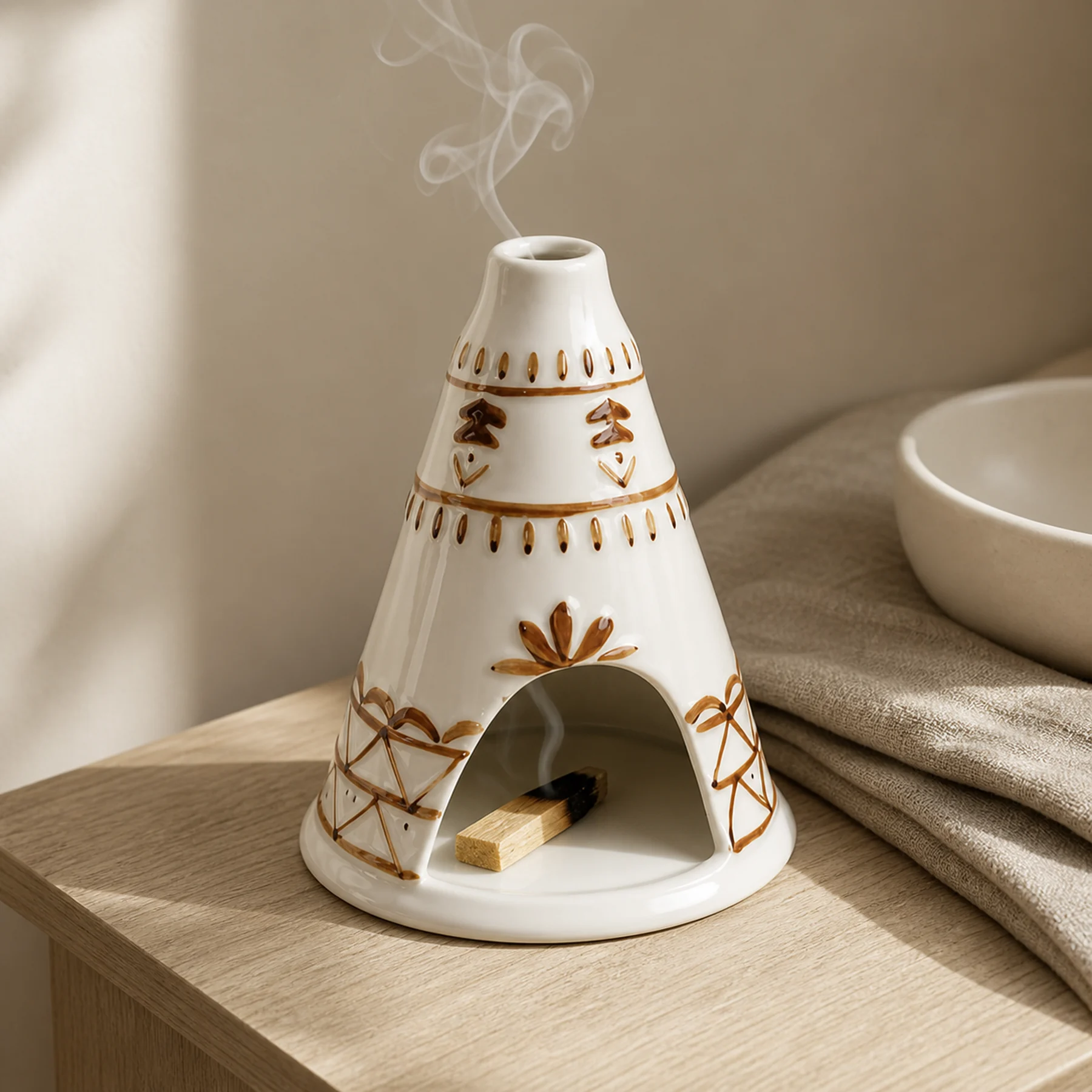 White ceramic Palo Santo holder with a smoldering wood stick inside